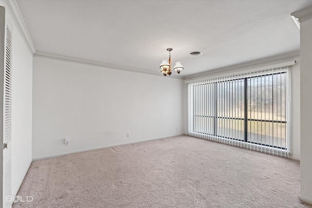 unfurnished room with carpet floors, visible vents, baseboards, ornamental molding, and an inviting chandelier