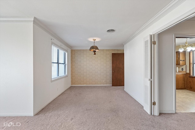 empty room featuring light carpet, ornamental molding, visible vents, and wallpapered walls