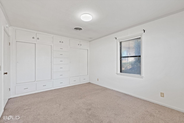 unfurnished bedroom with light carpet, visible vents, and baseboards