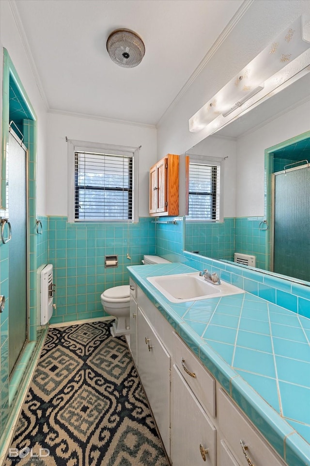 full bathroom with vanity, ornamental molding, tile walls, and tile patterned floors