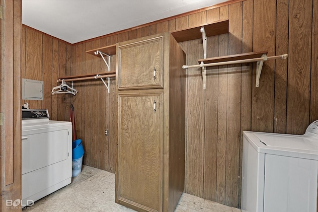 laundry room featuring laundry area, washer and clothes dryer, and wooden walls