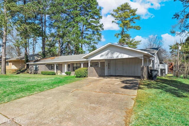 single story home featuring a front yard, concrete driveway, and brick siding