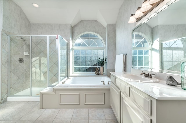 full bathroom with tile patterned floors, a stall shower, vaulted ceiling, vanity, and a bath