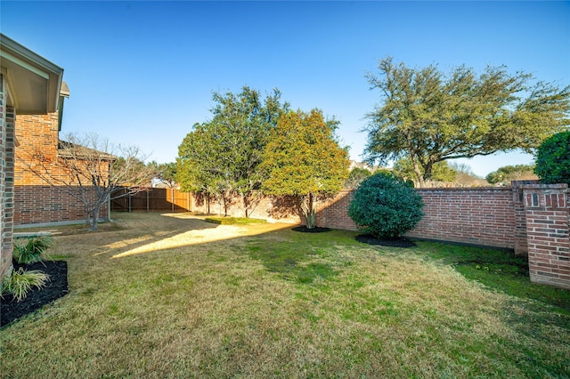 view of yard with a fenced backyard