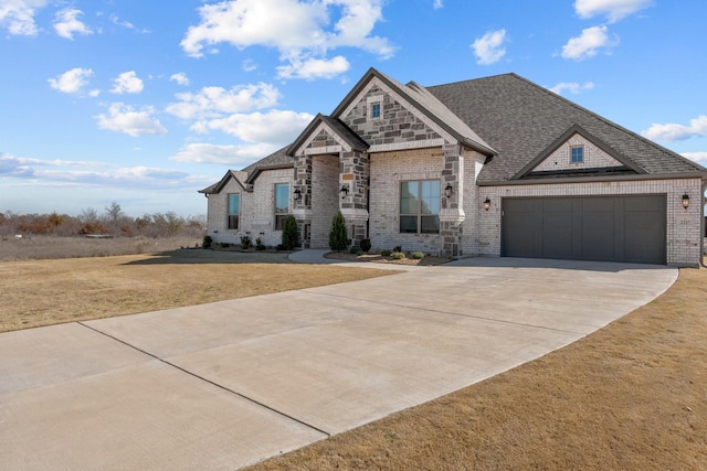 view of front of house featuring driveway, a garage, a shingled roof, a front lawn, and brick siding