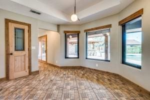 9577 Vail Eton Dr, Pilot Point, TX 76258 - spare room featuring brick patterned floors and a tray ceiling