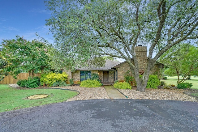 9577 Vail Eton Dr, Pilot Point, TX 76258 - mid-century modern home featuring a chimney and brick siding