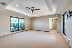 9577 Vail Eton Dr, Pilot Point, TX 76258 - spare room with a barn door, a ceiling fan, a raised ceiling, recessed lighting, and carpet flooring