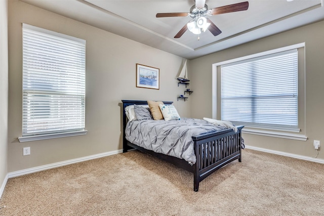 bedroom featuring carpet flooring, baseboards, and multiple windows