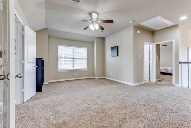 interior space with carpet, attic access, and baseboards