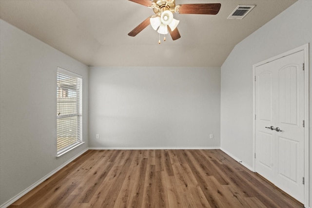 interior space with dark wood-style floors, baseboards, visible vents, and ceiling fan