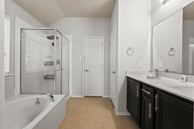 full bath featuring double vanity, a stall shower, a sink, and tile patterned floors