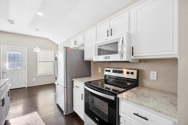 kitchen with appliances with stainless steel finishes, white cabinets, visible vents, and light stone counters