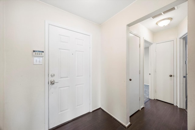 entryway featuring visible vents and dark wood-type flooring