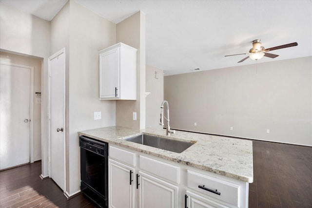 kitchen with dark wood-style floors, white cabinets, a sink, light stone countertops, and dishwasher