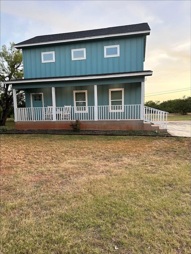 view of front of property with a yard and board and batten siding