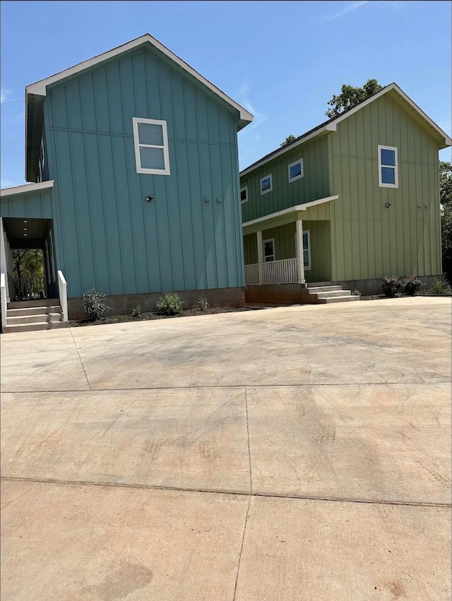 exterior space with covered porch and board and batten siding