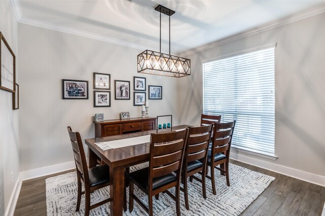 dining space with dark wood-style floors, baseboards, and ornamental molding