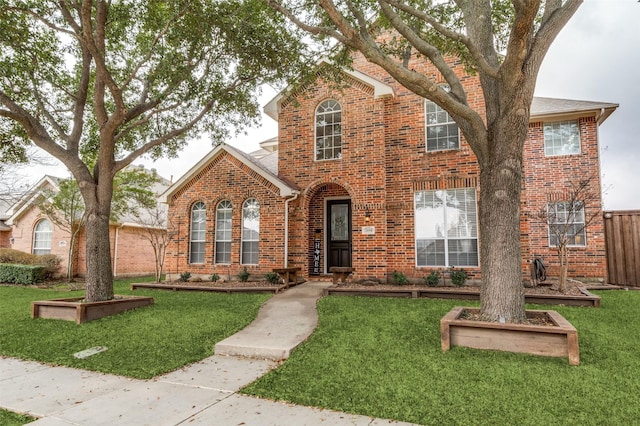 traditional home with brick siding and a front yard