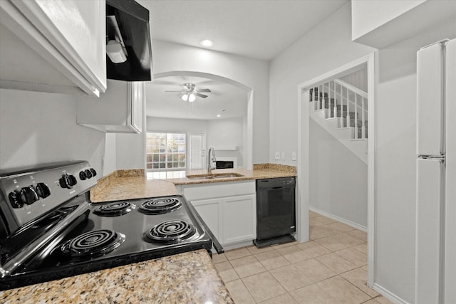 kitchen with arched walkways, range with electric stovetop, a sink, white cabinetry, and dishwasher