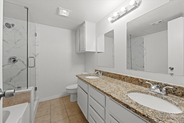 bathroom featuring a textured ceiling, a marble finish shower, a sink, and visible vents