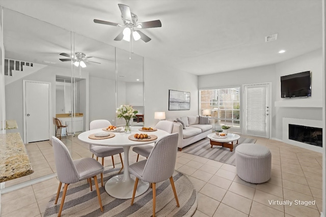 dining area featuring light tile patterned floors, visible vents, ceiling fan, a fireplace, and recessed lighting