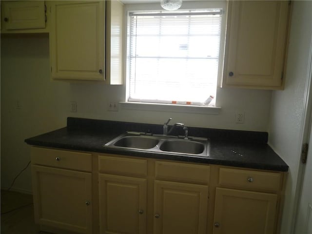 kitchen with dark countertops and a sink