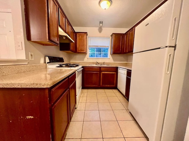 kitchen with white appliances, light stone counters, a textured ceiling, under cabinet range hood, and light tile patterned flooring