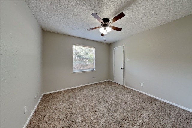 spare room featuring carpet floors, baseboards, and a textured ceiling