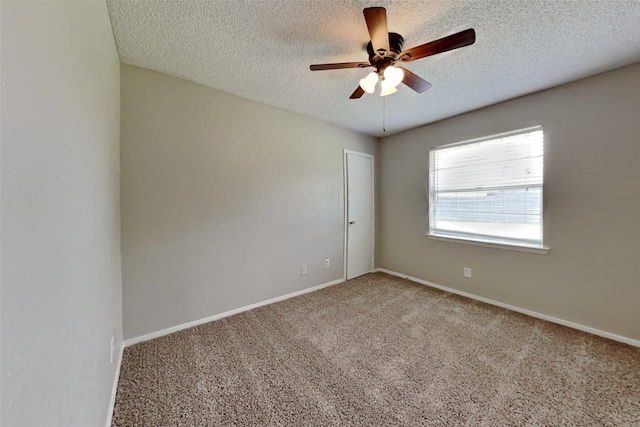 unfurnished room featuring a textured ceiling, ceiling fan, carpet, and baseboards