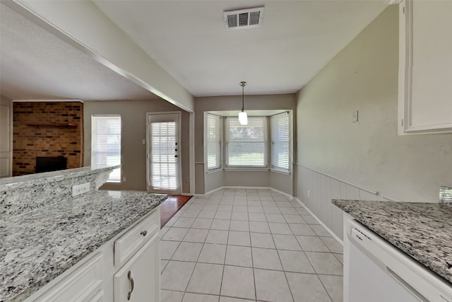 kitchen with light stone counters, pendant lighting, visible vents, white cabinetry, and dishwasher