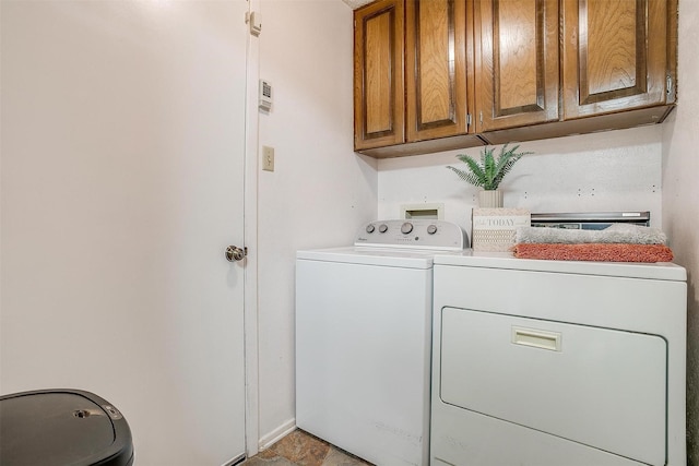 laundry room featuring cabinet space and washer and clothes dryer