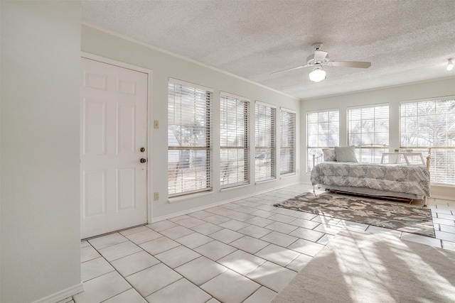 unfurnished sunroom featuring a ceiling fan