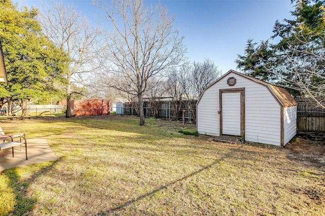 view of yard featuring an outbuilding, a shed, and a fenced backyard