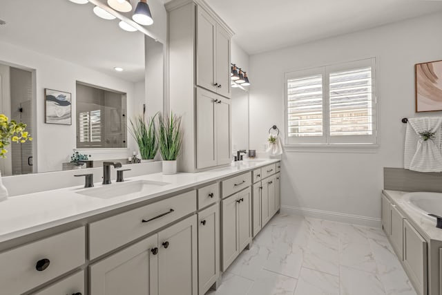 full bathroom featuring marble finish floor, double vanity, a stall shower, a sink, and baseboards