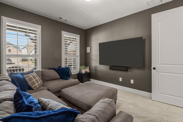 living room with carpet, visible vents, and baseboards