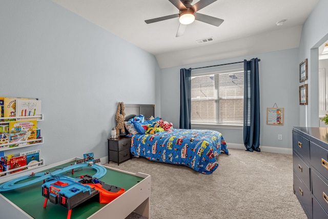 carpeted bedroom featuring baseboards, vaulted ceiling, visible vents, and ceiling fan