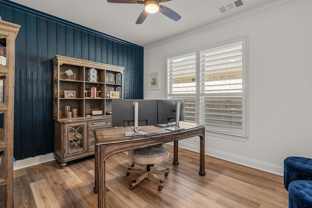 office with baseboards, wood finished floors, visible vents, and crown molding