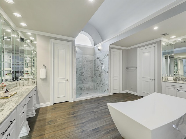 bathroom with a marble finish shower, visible vents, ornamental molding, wood finished floors, and recessed lighting