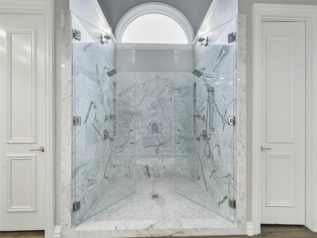 full bathroom featuring wood finished floors and a marble finish shower