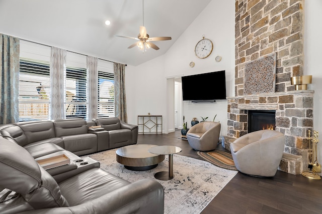 living area with high vaulted ceiling, dark wood finished floors, a fireplace, and a ceiling fan