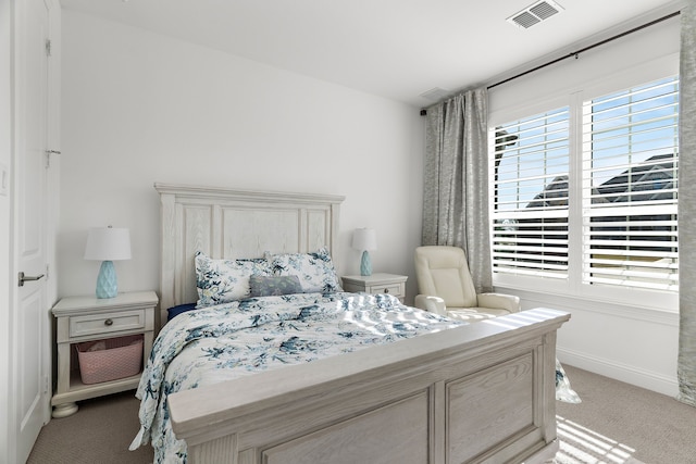 bedroom with visible vents, light carpet, baseboards, and multiple windows