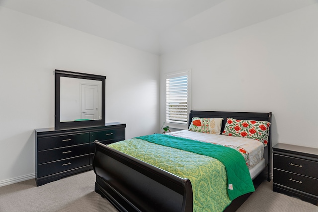 bedroom featuring baseboards and light colored carpet