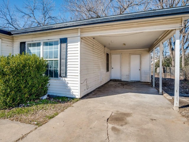 view of side of property with driveway and a carport