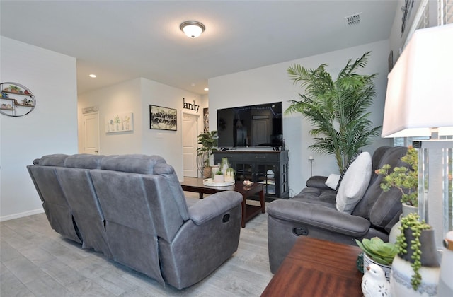 living area with recessed lighting, visible vents, light wood-style flooring, and baseboards