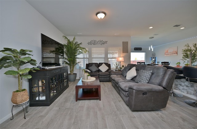 living area with wood finished floors and visible vents