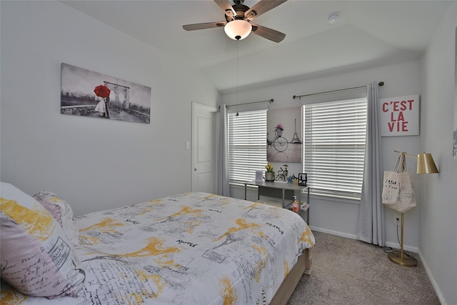 carpeted bedroom with lofted ceiling, a ceiling fan, and baseboards