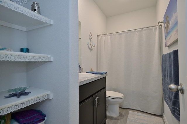 bathroom featuring toilet and vanity