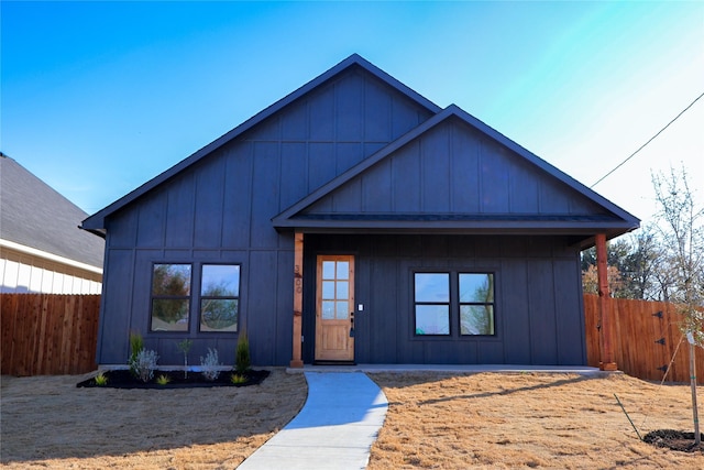 modern farmhouse featuring fence and board and batten siding