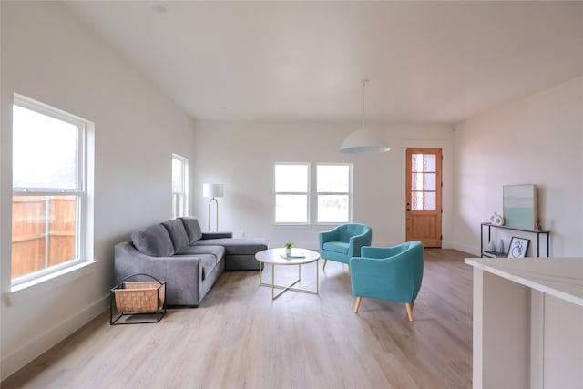 living area featuring light wood-style flooring and baseboards